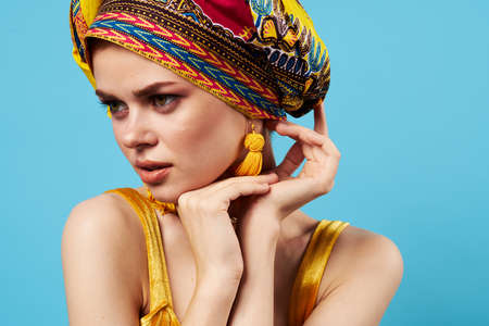 pretty woman ethnicity multicolored headscarf makeup glamor blue background