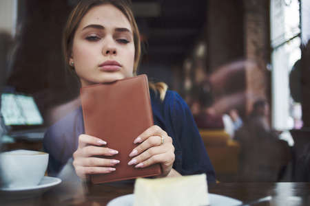 pretty woman in a cafe a cup of drink communication relaxation