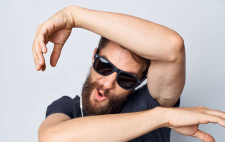 Cheerful man in a black t-shirt music in headphones movement isolated backgroundの写真素材