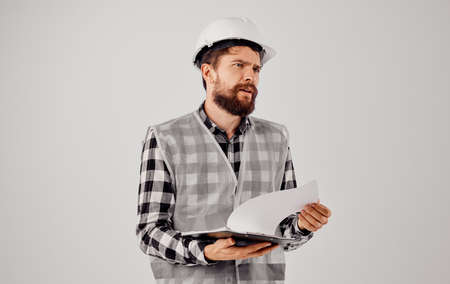 engineer in a white helmet blueprints Professional light backgroundの写真素材