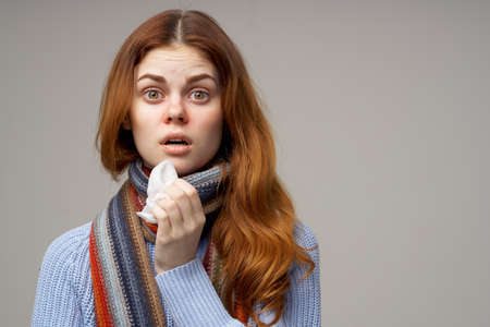 red-haired woman cold handkerchief close-upの写真素材