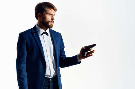 Man Secret agent with a gun in the hands of a crime isolated backgroundの写真素材