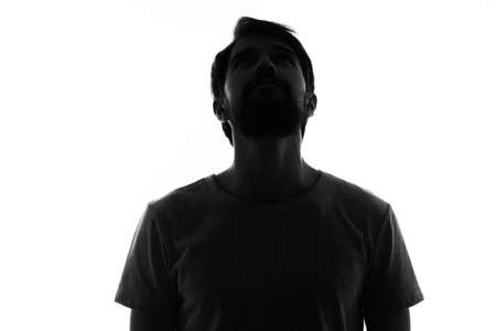 man posing in the shadows anonymous studioの写真素材