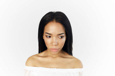 woman of african appearance in white dress cosmetics on face cropped view modelの写真素材