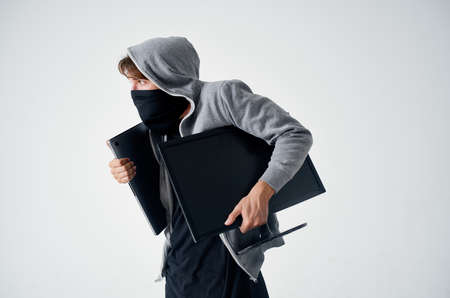 hacker crime anonymity caution balaclava light backgroundの写真素材