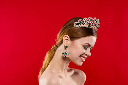 beautiful woman with a crown on her head makeup decoration isolated background