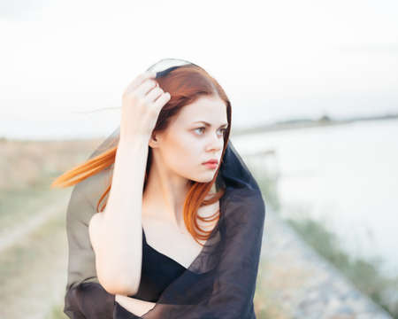 attractive woman fashion black dress nature fresh airの写真素材