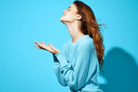 beautiful woman in a blue sweater blue background Lifestyle