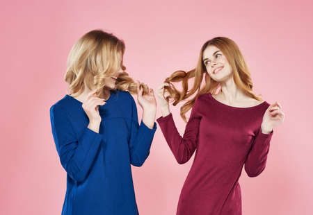 two girlfriends in dresses fashion posing studioの写真素材
