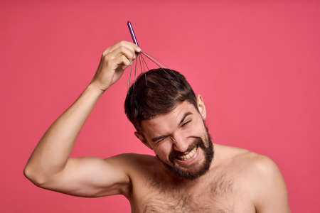 bearded man with head massager rest morning