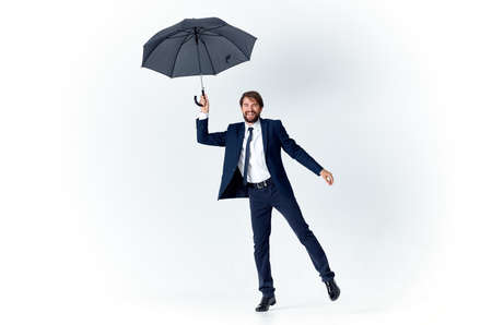 man in suit holding an umbrella in his hands elegant style weather rainの写真素材