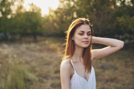 attractive woman in a field in nature sun freedomの写真素材
