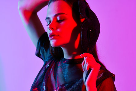 woman in fashion clothes Cosmetics disco charm neon light studioの写真素材