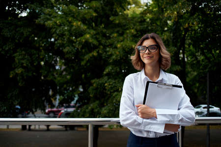 woman in suit with folder for papers Professional light backgroundの写真素材