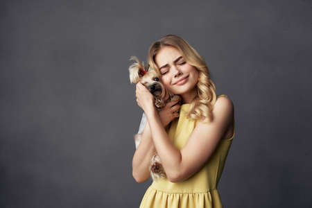 blonde with a small dog makeup posing isolated backgroundの写真素材