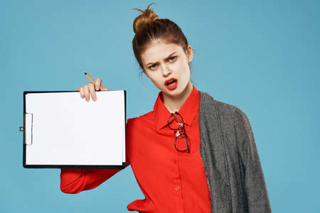 Business woman with a jacket on her shoulders a sheet of paper Copy Space blue backgroundの写真素材