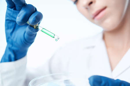 woman with blue gloves laboratory research science