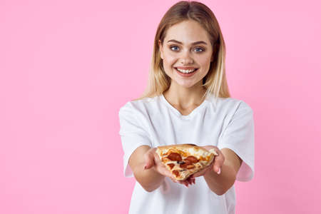 cheerful pretty woman in white t-shirt pizza fast food snack restaurantの写真素材