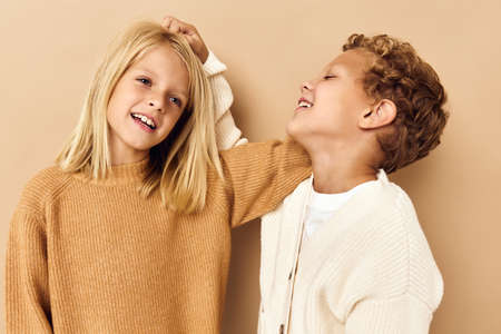 boy and girl smiling and posing in casual clothes isolated backgroundの写真素材