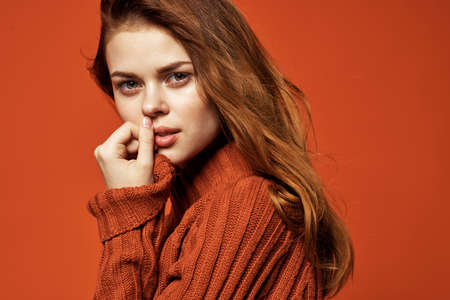 woman in red sweater glamor fashion posing isolated backgroundの写真素材