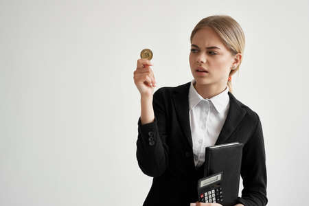 Businesswoman with documents in the hands of finances light backgroundの写真素材