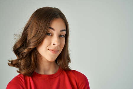 beautiful woman surprised look emotions light backgroundの写真素材