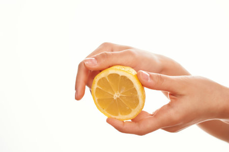 lemon in hand salad ingredient close-upの写真素材