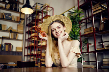 beautiful woman with a book in the hands of a cafe fashionの写真素材