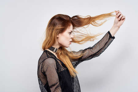 pretty woman attractive look modern style jewelry emotions light backgroundの写真素材