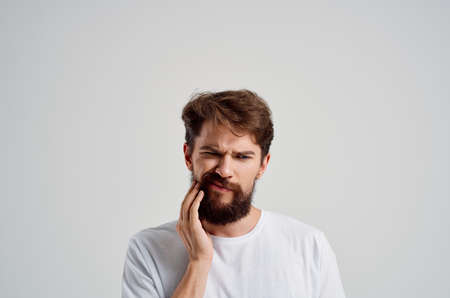 emotional man dental problem dentistry treatment light backgroundの写真素材