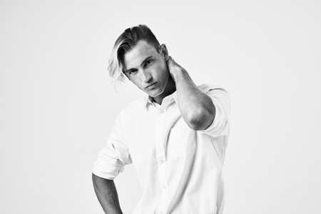 a man with a fashionable hairstyle in a white shirt attractive look modelの写真素材