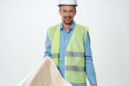 man in construction uniform blueprints builder isolated backgroundの写真素材