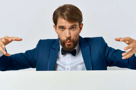 bearded man white banner in hand blank sheet presentation copy-space studioの写真素材