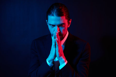 portrait of a man in costume posing fashion dark backgroundの写真素材