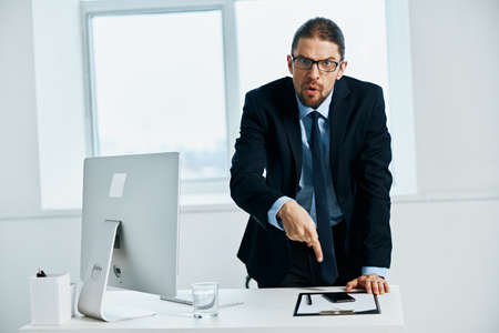 businessman in the office gestures with his hands computerの写真素材