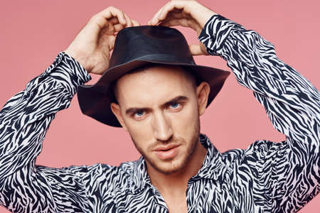 fashionable man shirt posing self confidence pink backgroundの写真素材