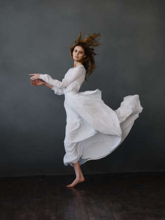 Woman in white dress dance movement performanceの写真素材