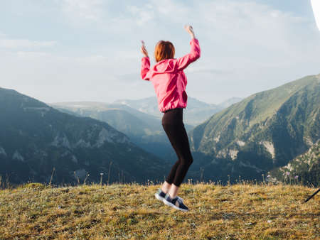 cheerful woman in the mountains nature outdoor activities jumpの写真素材