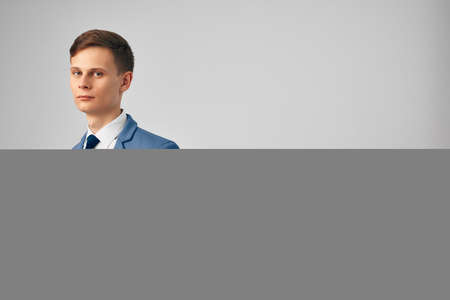 man in a suit with documents in his hands professional office light backgroundの写真素材