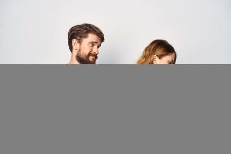 Man and woman in black t-shirts phone fun together friendship isolated backgroundの写真素材