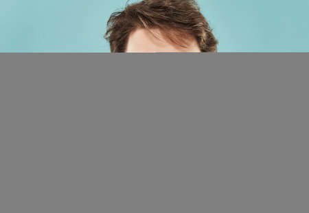 Man in a white t-shirt hand gestures anger blue backgroundの写真素材