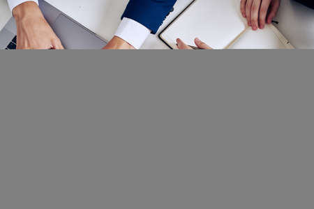 business man and woman teamwork in the office with laptop technologyの写真素材