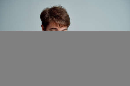 sick man wiping his nose with a handkerchief health problems light backgroundの写真素材