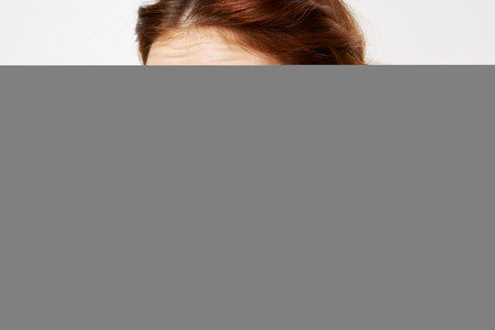 pretty woman fluffy earrings bare shoulders close-up bright makeupの写真素材