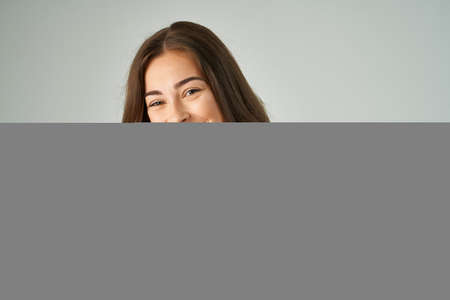 beautiful woman in a red t-shirt hair care light backgroundの写真素材