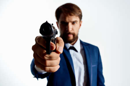 businessmen Secret agent with a gun in the hands of a crime isolated backgroundの写真素材