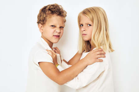 The boy is offended by the little girl fight naughty isolated backgroundの写真素材