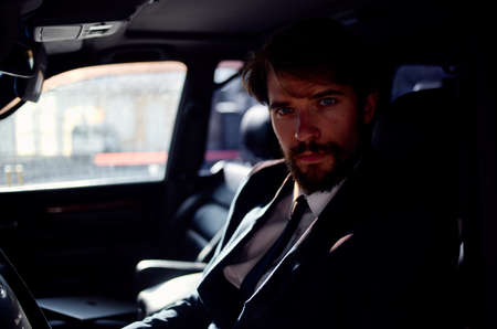 emotional man in a suit in a car a trip to work self confidenceの写真素材