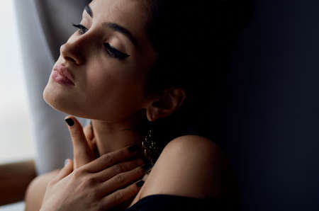 beautiful woman holding a camera near the window decoration fashion elegant styleの写真素材