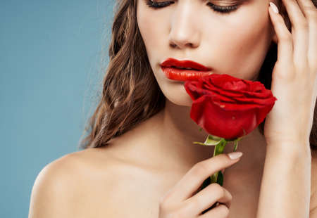 brunette attractive look rose flower Red lips glamorの写真素材